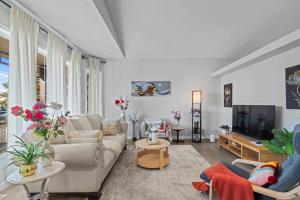 a living room with a couch and a tv at Spacious & Comfy Upper Floor 3BR Suite in Detached House in Calgary