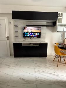 a living room with a flat screen tv on a wall at Ocean Flat com vista pro mar 604 in Vila Velha