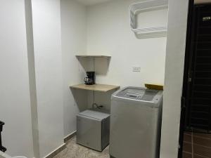 a washer and dryer in a corner of a room at San Luis Apartamento 202 Cúcuta in Cúcuta +6 photos