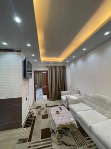 a living room with a couch and a table at استديوهات3 Hs Hotels استديو مخدوم in Cairo