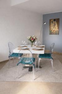 a dining room table with two chairs and a vase of flowers at Charming & Cosy duplex - city in Luxembourg