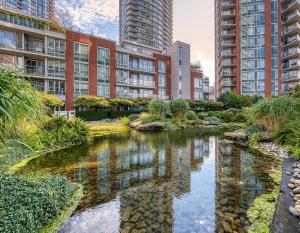 a river in a city with tall buildings at Modern 2BR Luxury Apartment - Amazing Location, Steps To Everything! in Vancouver