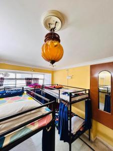 a room with two bunk beds and a chandelier at Tamasha Udaipur in Udaipur