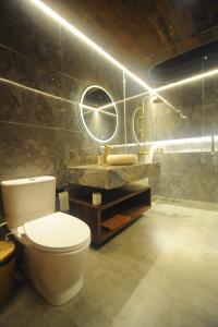 a bathroom with a toilet and a sink at Uma Cabins by Uma Experience in Penginyahan +30 photos