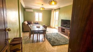 a living room with a table and a couch at لوزان ابارتمنت in Dawwār Siwākah +4 photos