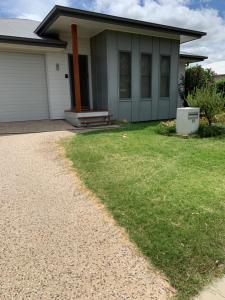 a house with a gravel driveway in front of it at Grace Guest Rooms in Roma