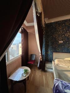 a bedroom with a bed and a table and a window at Tamasha Udaipur in Udaipur +72 photos