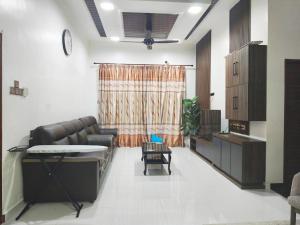a living room with a couch and a table at Casa Ariana Machang 3B3R in Macang