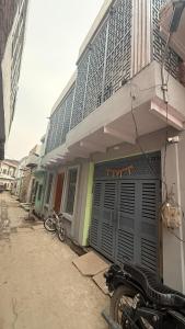 a motorcycle parked in front of a building at Sneham home stay in Vrindāvan