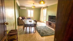 a living room with a table and a couch at لوزان ابارتمنت in Dawwār Siwākah