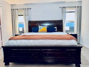 a bedroom with a large bed with two windows at Pelican Pointe Home for 10 in Bolivar Peninsula +62 photos