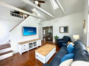 a living room with a blue couch and a table at Coastal Cape Cod w/ King Bed, Game Room, & Bikes! in Vermilion