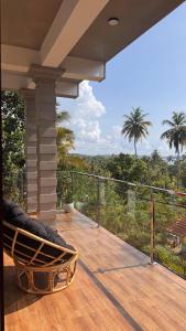 a porch with a chair and a view of the forest at Ceylan Dream Hiriketiya in Nilwella