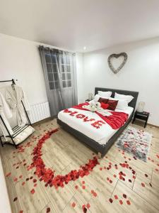 a bedroom with a bed with red roses on the floor at Vitospa in Cauffry +13 photos
