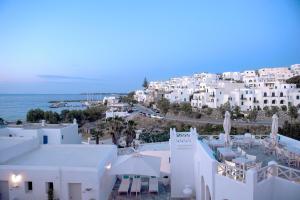 an aerial view of a town with white buildings and the ocean at Kanale's Rooms & Suites in Naousa