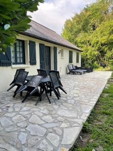 a group of chairs sitting on a stone patio at Vitospa in Cauffry