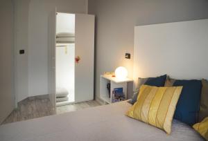 a bedroom with a bed with a yellow pillow on it at A Casa di Renata in Cosenza