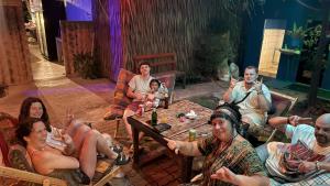 a group of people sitting around a table at 99Hostel&Bar Koh Chang in Ko Chang
