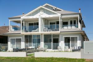 a large white house with a lot of windows at Waves at Warilla in Barrack Point