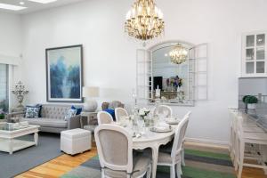 a dining room and living room with a table and chairs at Waves at Warilla in Barrack Point