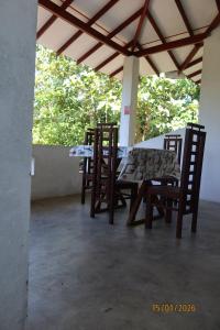 a table and chairs sitting on a patio at natura villa in Dickwella