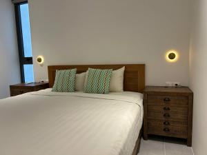 a bedroom with a bed with a wooden headboard at Windy Beach House 1 in Ấp Bình Tú