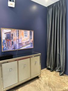 a flat screen tv sitting on top of a entertainment center at Windy Beach House 1 in Ấp Bình Tú +10 photos
