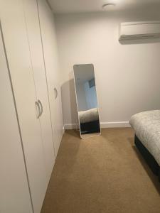 a mirror sitting on the floor in a bedroom at 204 The Sands in Nelson
