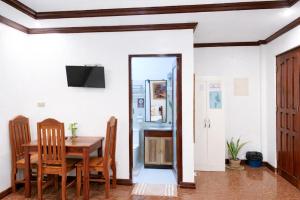 a dining room with a table and chairs and a mirror at PEPAYEN Homestay in General Luna