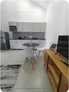 a kitchen with a table and chairs in a room at Atloch in Kimberley