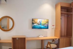 a room with a desk with a computer on a wall at Lakeside TELL Cikarang in Ceper 2