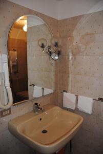 a bathroom with a sink and a mirror at Hotel Del Viale in Courmayeur