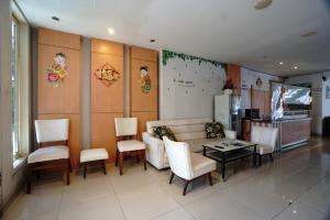 a living room with a couch and a table and chairs at Buring Residence By TOS Malang in Samaan