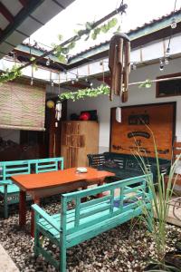 a picnic table and benches in a patio at Rumah Panjaitan in Yogyakarta