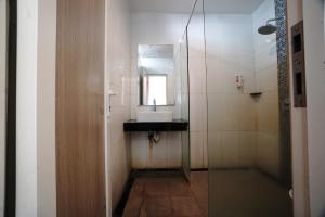 a bathroom with a sink and a mirror at Buring Residence By TOS Malang in Samaan