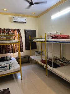 a room with three bunk beds and a ceiling at Rv stay pushkar in Pushkar