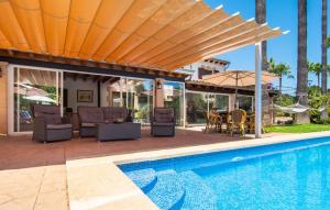 a patio with a pool and chairs and an umbrella at Can Tomeu De Llubi in Llubí +50 photos
