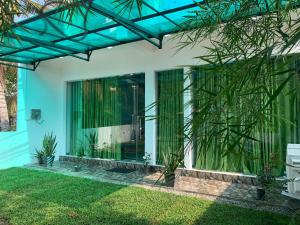 a house with a glass facade at Nomin Villa in Kottagoda