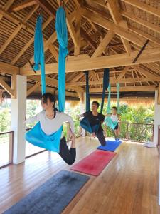 a group of people doing yoga in a gym at Mantra Yoga Homestay in Tanjung