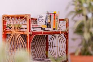 a book shelf with books on top of it at Sanctuary Cove Guest House in Polonnaruwa