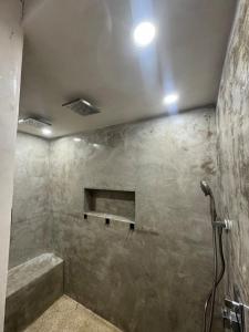 a bathroom with a shower with a stone wall at Casa Baja, with Gym & Terraces in La Paz +42 photos
