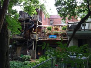 an apartment building with balconies and a staircase at Gite L'Imprévu in Montréal