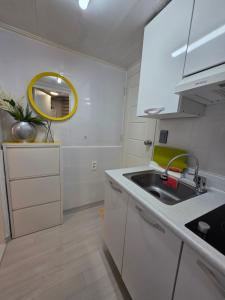 a kitchen with a sink and a mirror at dalcom kunkuk in Seoul +8 photos