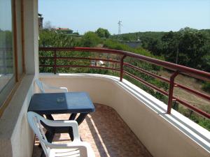 a balcony with a blue table and two chairs at Villa Victoria in Sinemorets