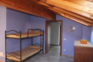 a room with three bunk beds in a house at Paradiso sul Lago Maggiore in Baveno