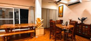 a dining room with a table and chairs and a window at The Selakhola House in Bhīm Tāl