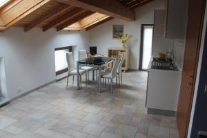 a kitchen and dining room with a table and chairs at Paradiso sul Lago Maggiore in Baveno