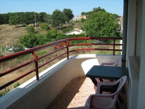 a balcony with a table and chairs and a fence at Villa Victoria in Sinemorets