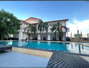 a large swimming pool in front of a building at Bellamoon Resort in Trincomalee
