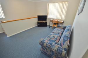a living room with a couch and a table at Blue Ocean Villa 7 - Kalbarri, WA in Kalbarri